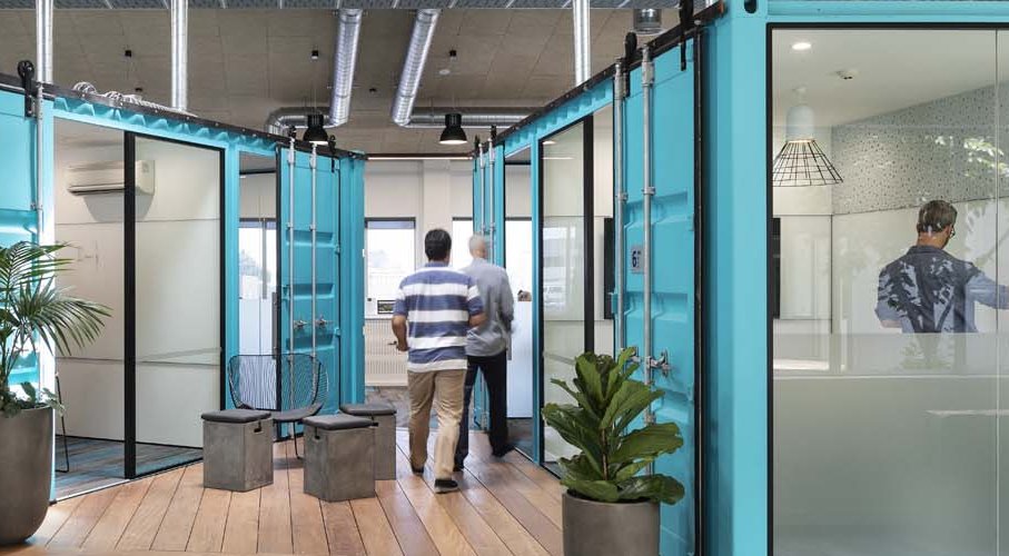 Feature shipping container units have been converted into central meeting rooms HEB Construction, Auckland headquarters by Unispace (VINCI Group)