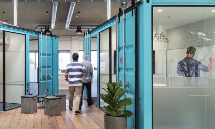 Feature shipping container units have been converted into central meeting rooms HEB Construction, Auckland headquarters by Unispace (VINCI Group)